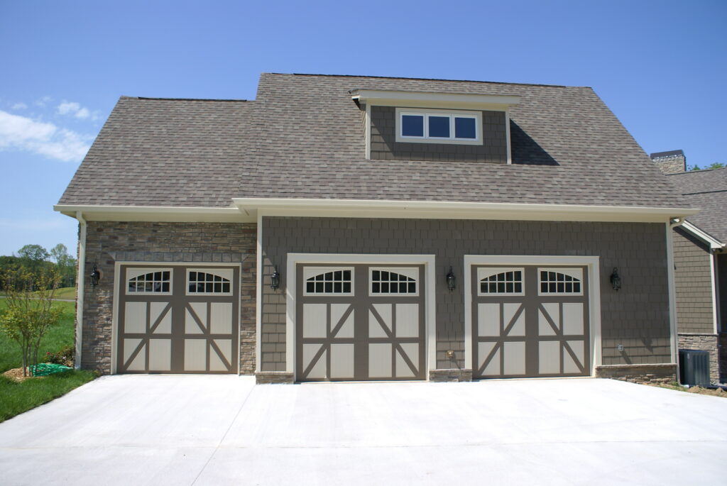 three gray and white carriage house garage doors installed
